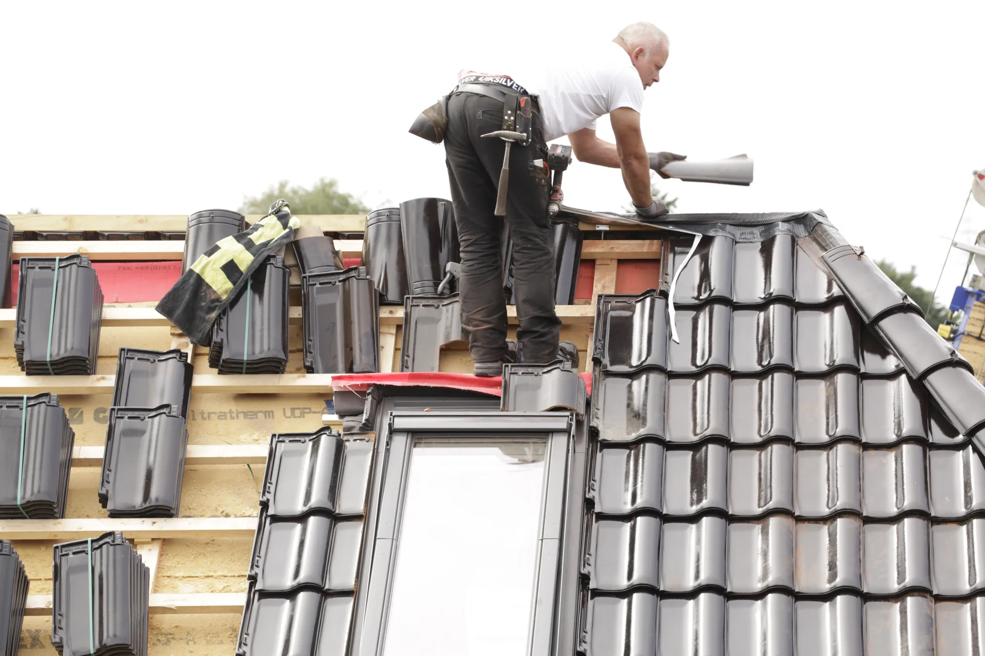 Roofer installing ridge tiles
